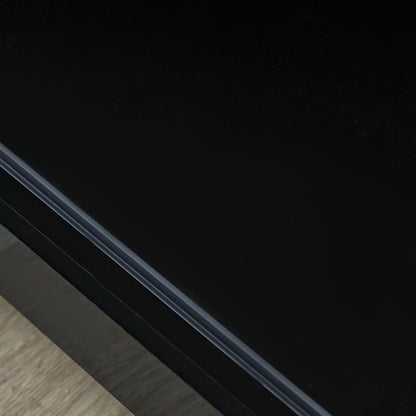 Modern Home black media console surface with a sleek, minimalist finish and smooth edge detail.
