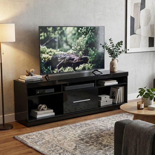 Modern Home black media console with open shelves and a central cabinet, styled in a contemporary living room.