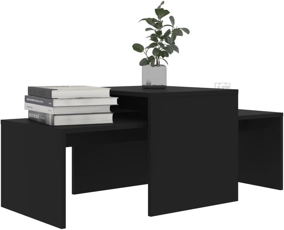 Modern Home black nesting coffee table set with minimalist geometric design and a small potted plant on top.