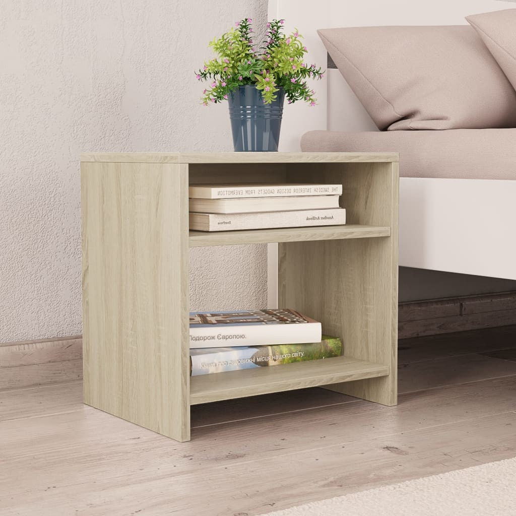 Modern Home light oak wood bedside table with two open storage shelves next to a bed with a potted plant on top