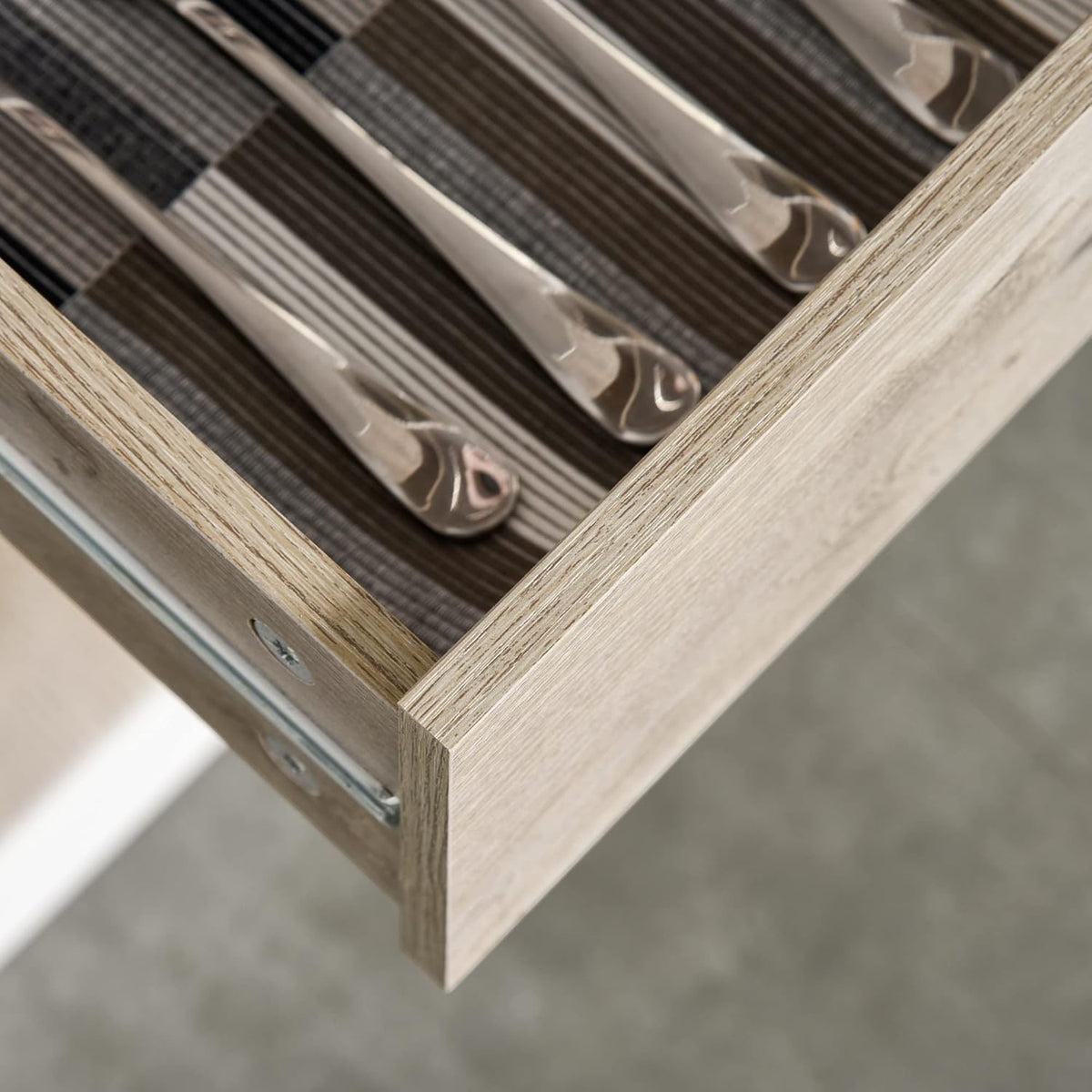 Modern Home kitchen pantry cabinet drawer with wood grain finish and organized silver cutlery inside