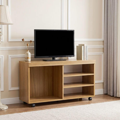 Modern Home rolling media console in natural wood finish with open shelving and a television in a living room setting.