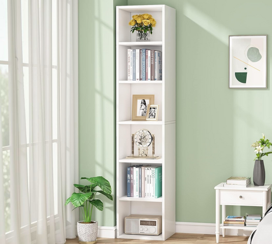 Modern Home tall white six-tier vertical bookshelf in a bright living room corner with books and decor items.