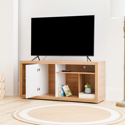 Modern Home two-tone TV stand with wood-grain finish and white cabinet door, featuring open shelving and a television.