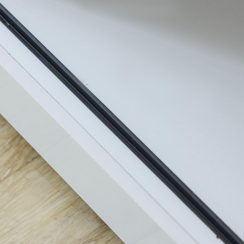 Close-up of the white Modern Home media console shelf edge with a sleek black trim detail.