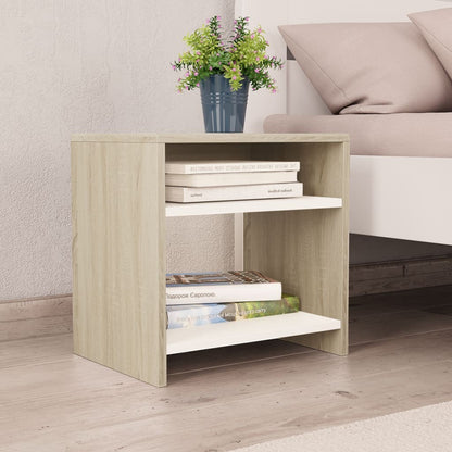 Modern Home white and light wood bedside table with two open shelves for storage next to a bed