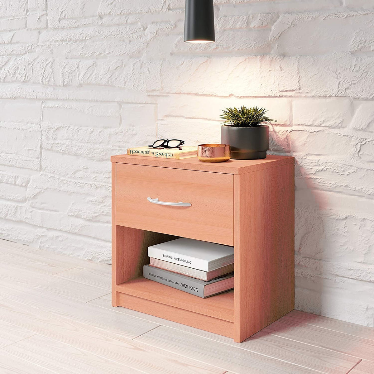 Modern Home wooden bedside table with a drawer and open shelf, featuring an aluminum handle against a brick wall.
